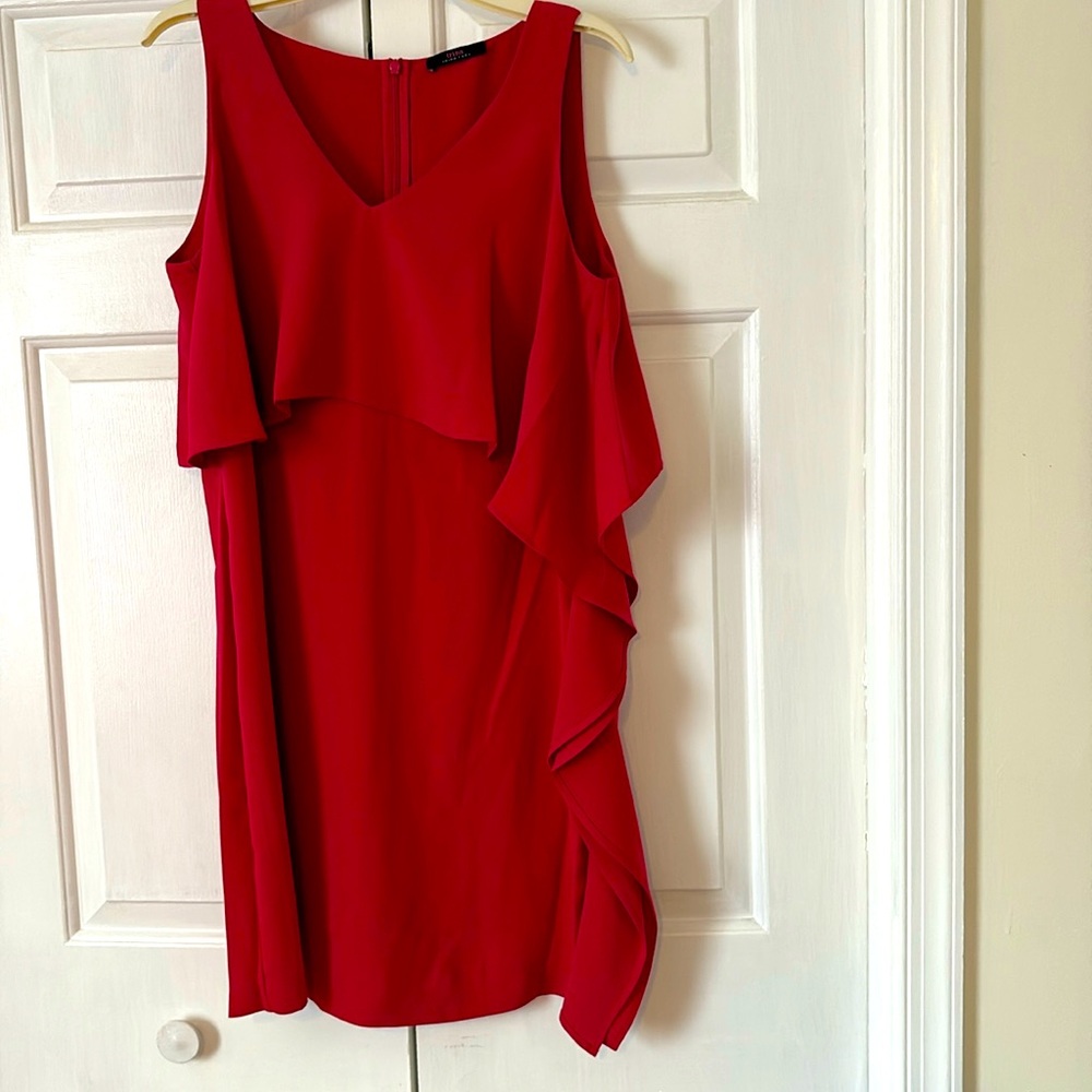 New without tags. Elegant Trina Turk Sleeveless Dress with side ruffle.